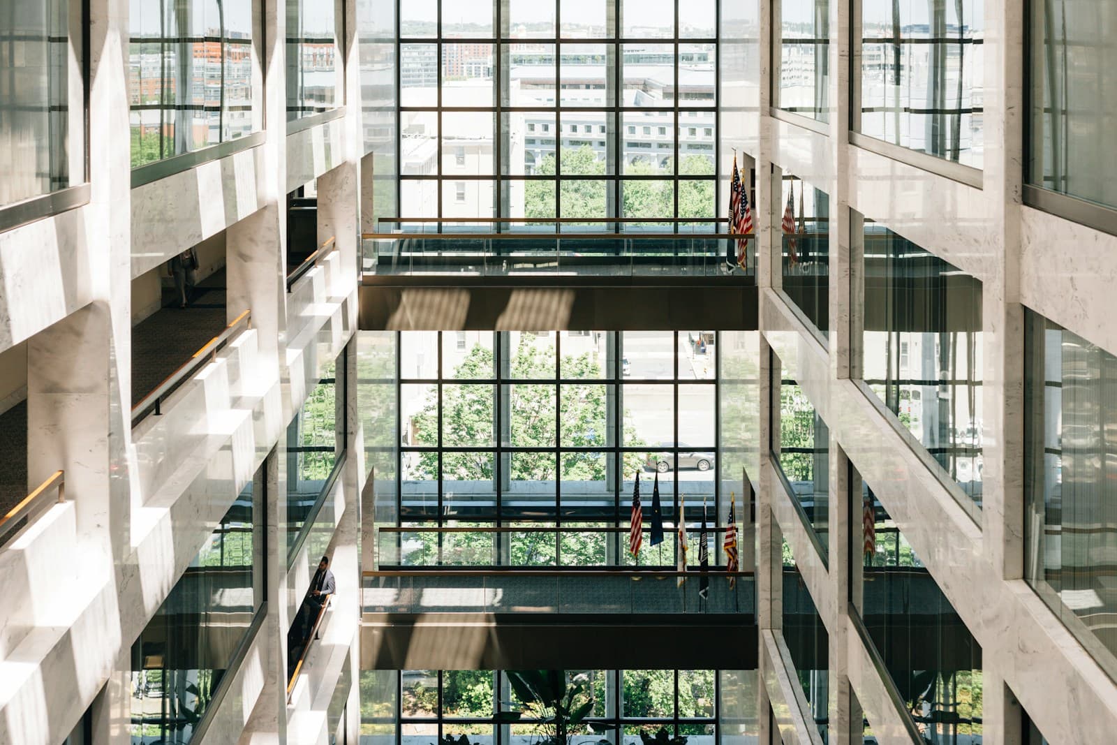 A beige and grey concrete civic building seen from below